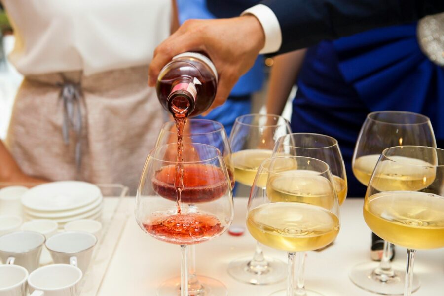 person pouring wine as they mull the criteria for alcoholism