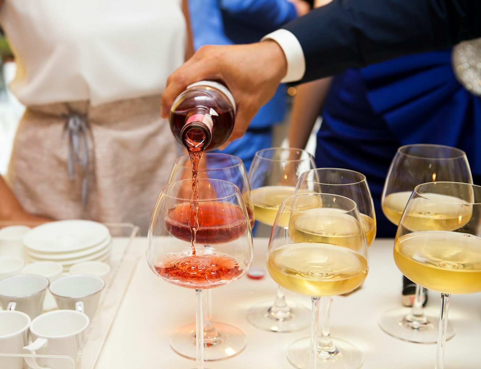 person pouring wine as they mull the criteria for alcoholism
