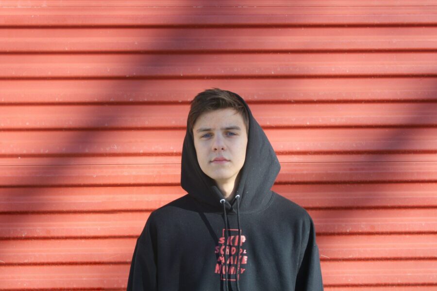man wearing black and red pullover hoodie, concerned about K2 spice addiction