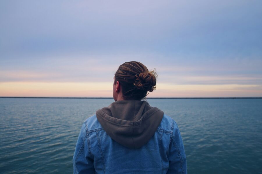 Man overlooking the ocean questioning a lapse vs relapse