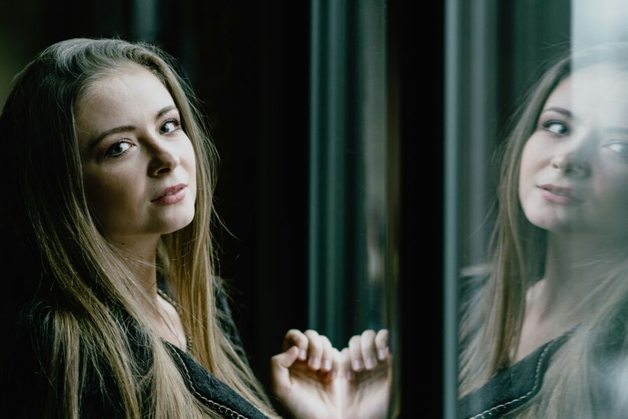 Woman in mirror representing transfer addiction