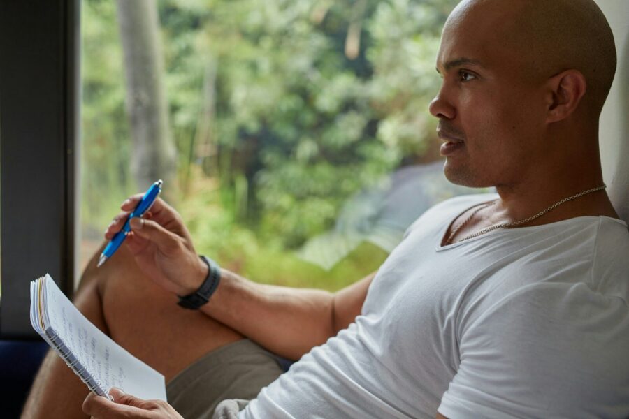 man sitting on couch, working on his 7OH addiction