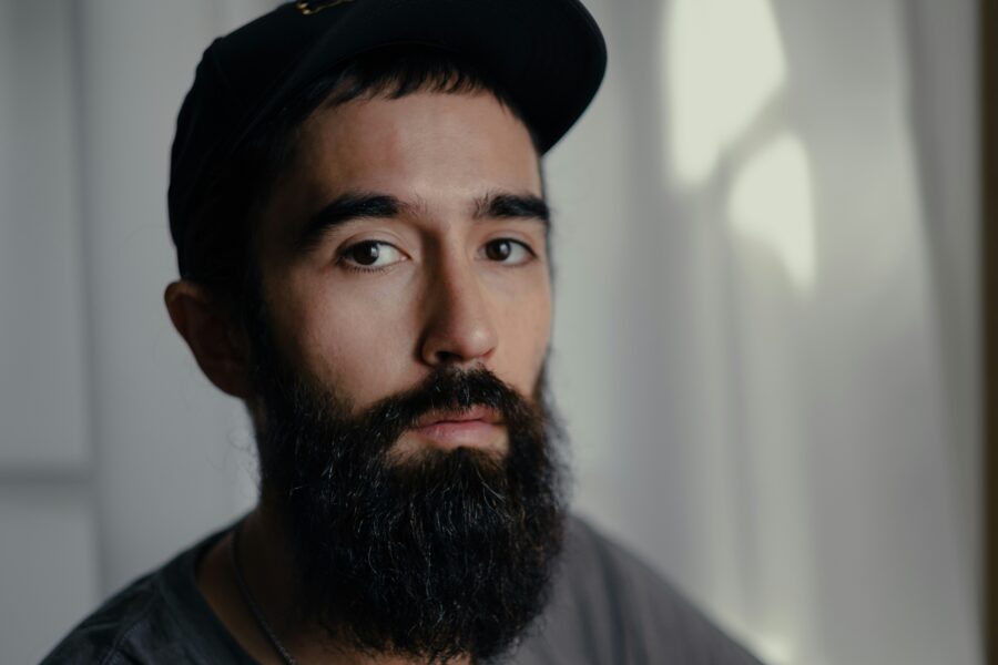 Man in hat realizing, "I relapsed"