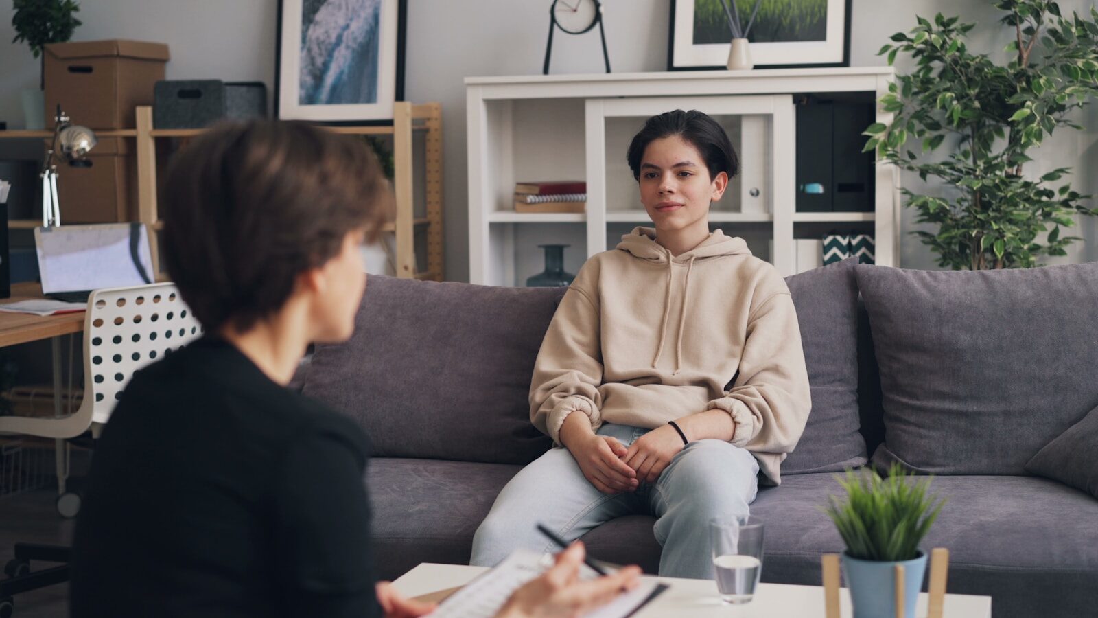 a woman in an intensive outpatient program sitting on a couch talking to another woman
