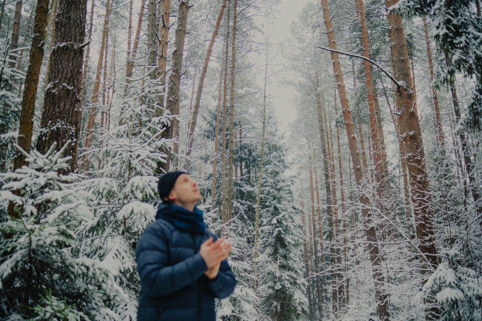 A person struggling with depression and substance abuse in a snowy forest