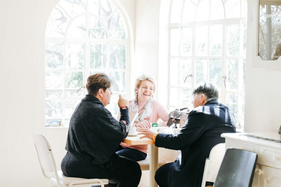 a group of people sitting around a table discussing addiction and lying