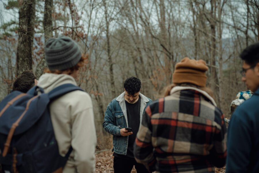 Man looking at his phone and reading about the signs of opioid abuse