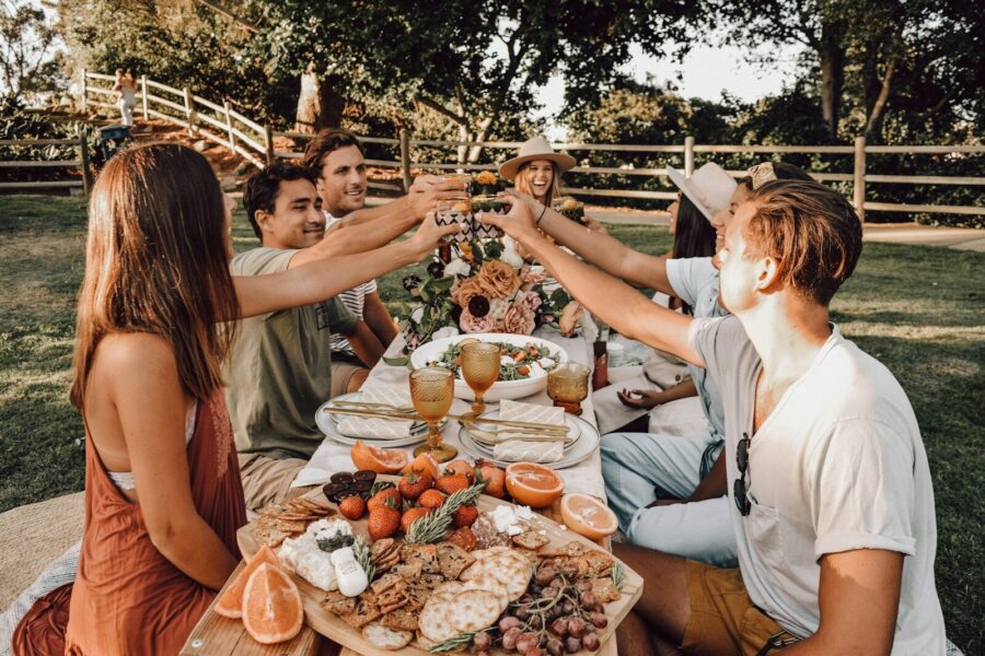 Sober curious people sitting on chair eating food during daytime