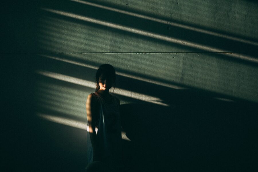 Women in the shadows showing signs of cocaine addiction