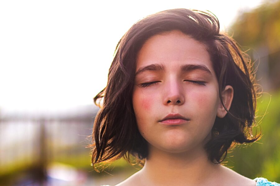 Woman with eyes closed practicing breathwork