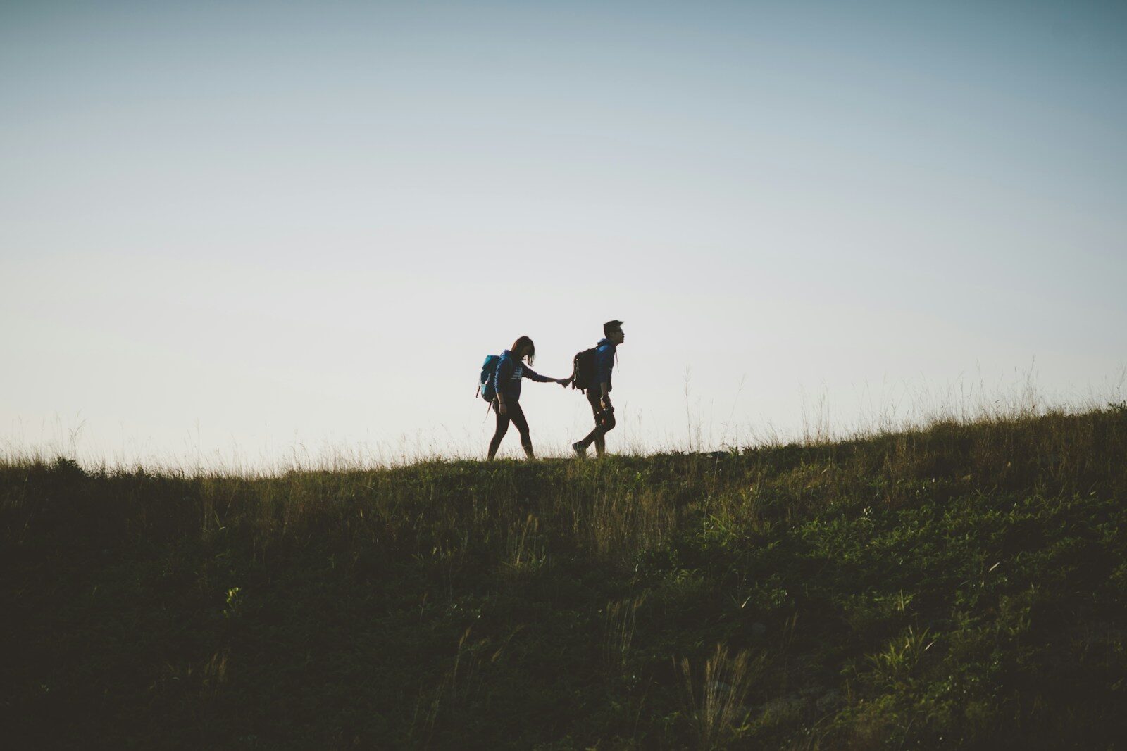 couple walking on hill being vulnerable together