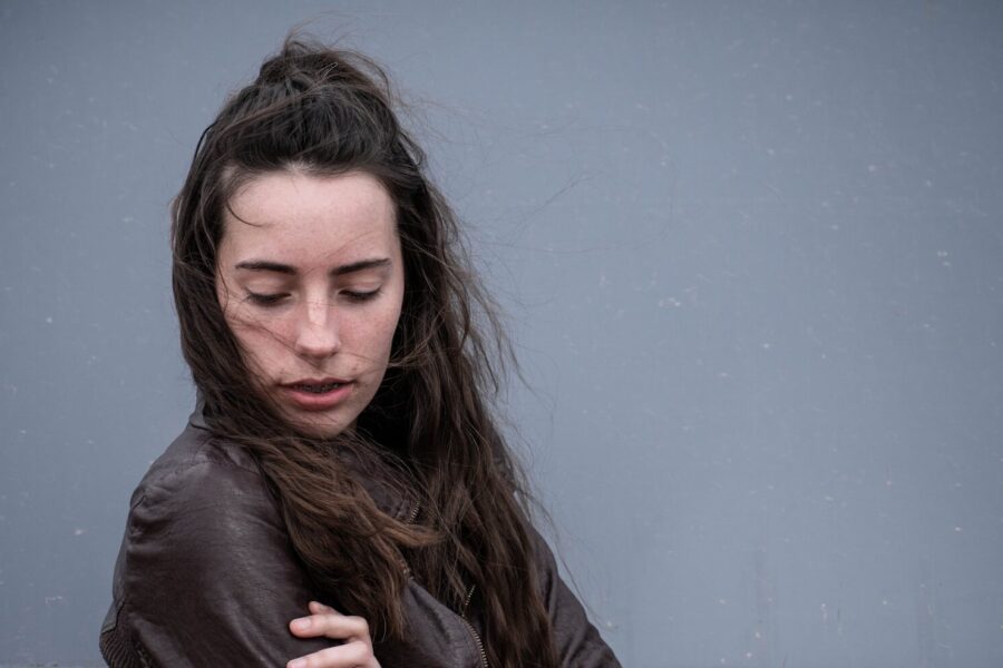 woman dealing with depression after drinking looking downwards